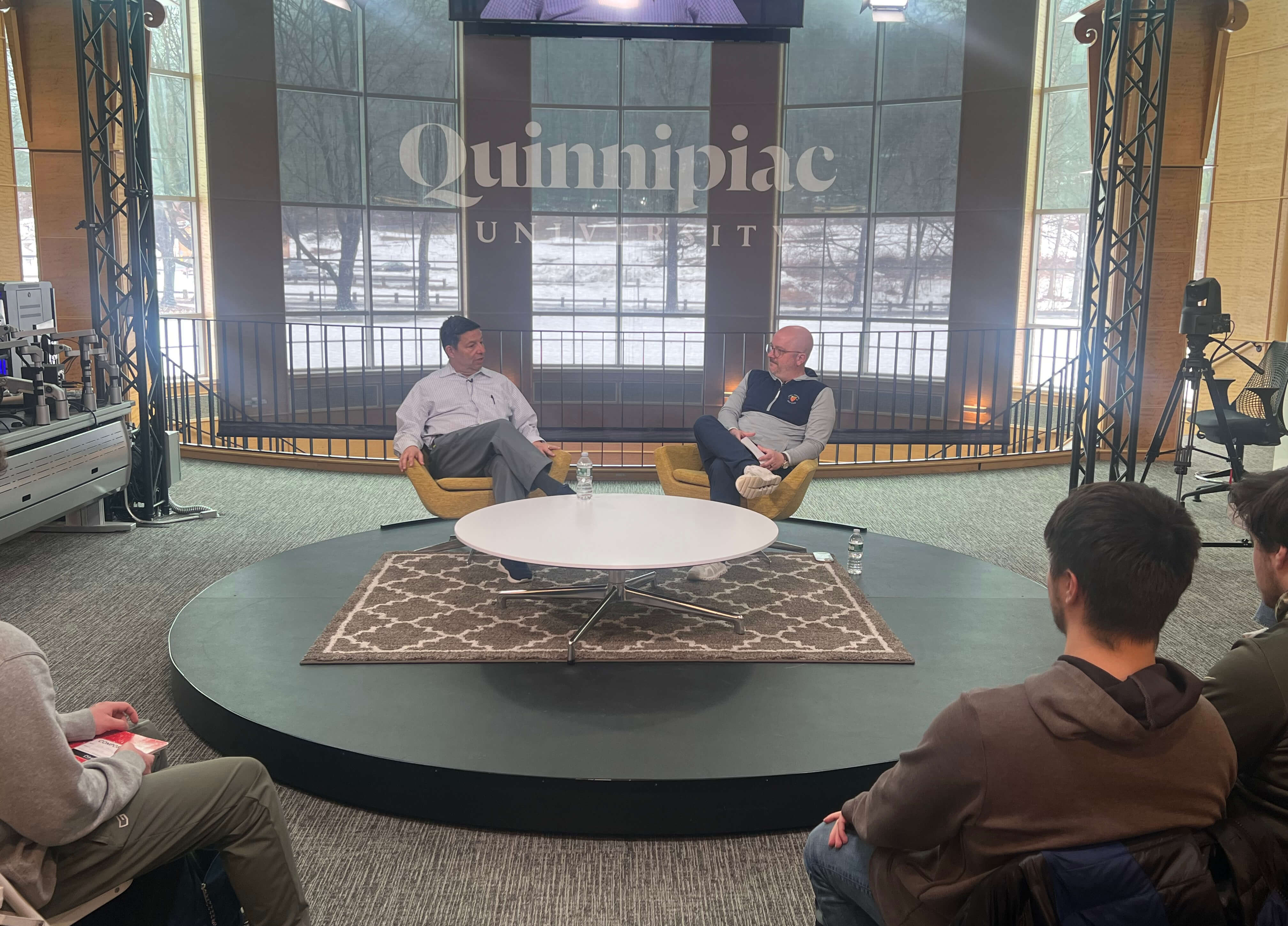 Quinnipiac University student Jake Hughes, left, talks with ESPN bracketologist Joe Lunardi