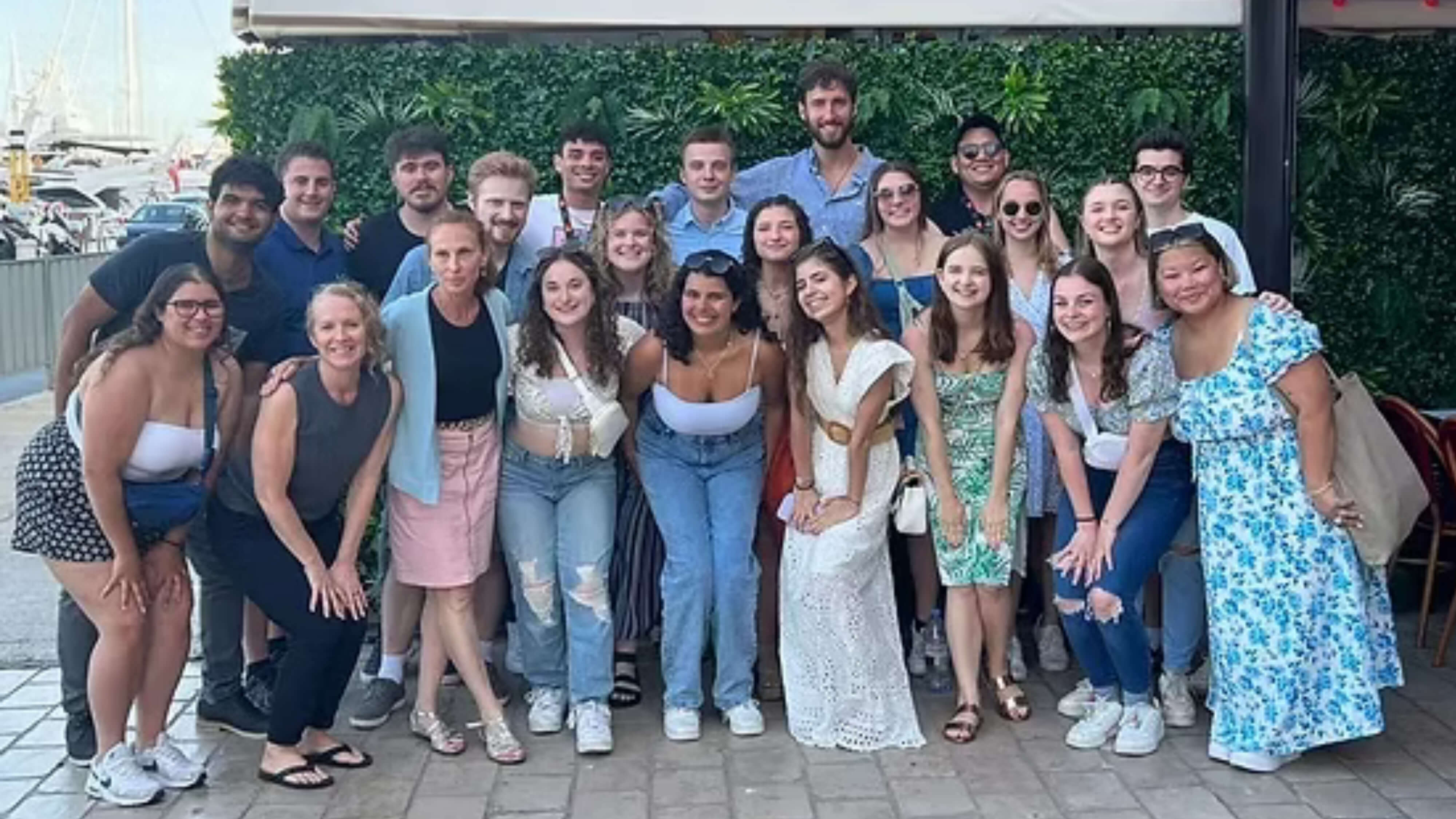 A group of Quinnipiac Students standing together and posing for a photo in Cannes, France.