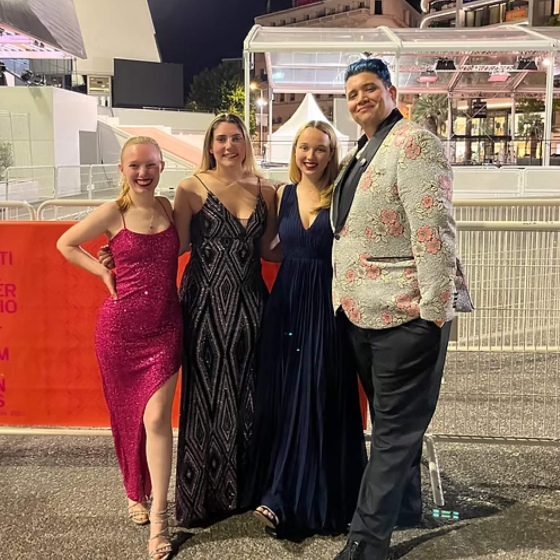 A photo of four students posing for a photo at the Cannes Film Festival red carpet event.
